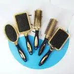 Brosse à cheveux avec coussin d'air et poignée ergonomique antidérapante dorée