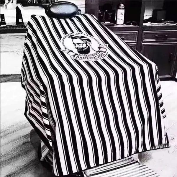 Cape de coiffure à rayures noires et blanches pour salon de coiffure et barbier