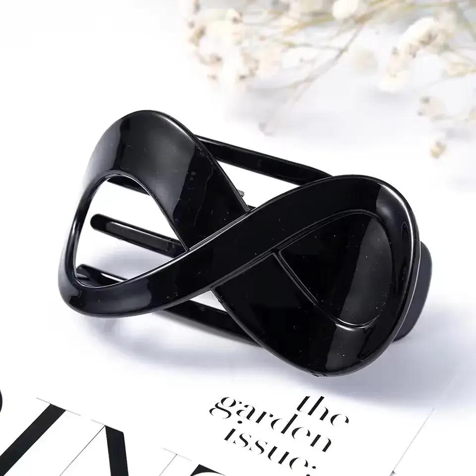 Pinza per capelli con design intrecciato a forma di infinito - Nero lucido